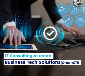 Man working simultaneously on a tablet and keyboard with blue holographic lights and icons, representing IT consulting in Oman.